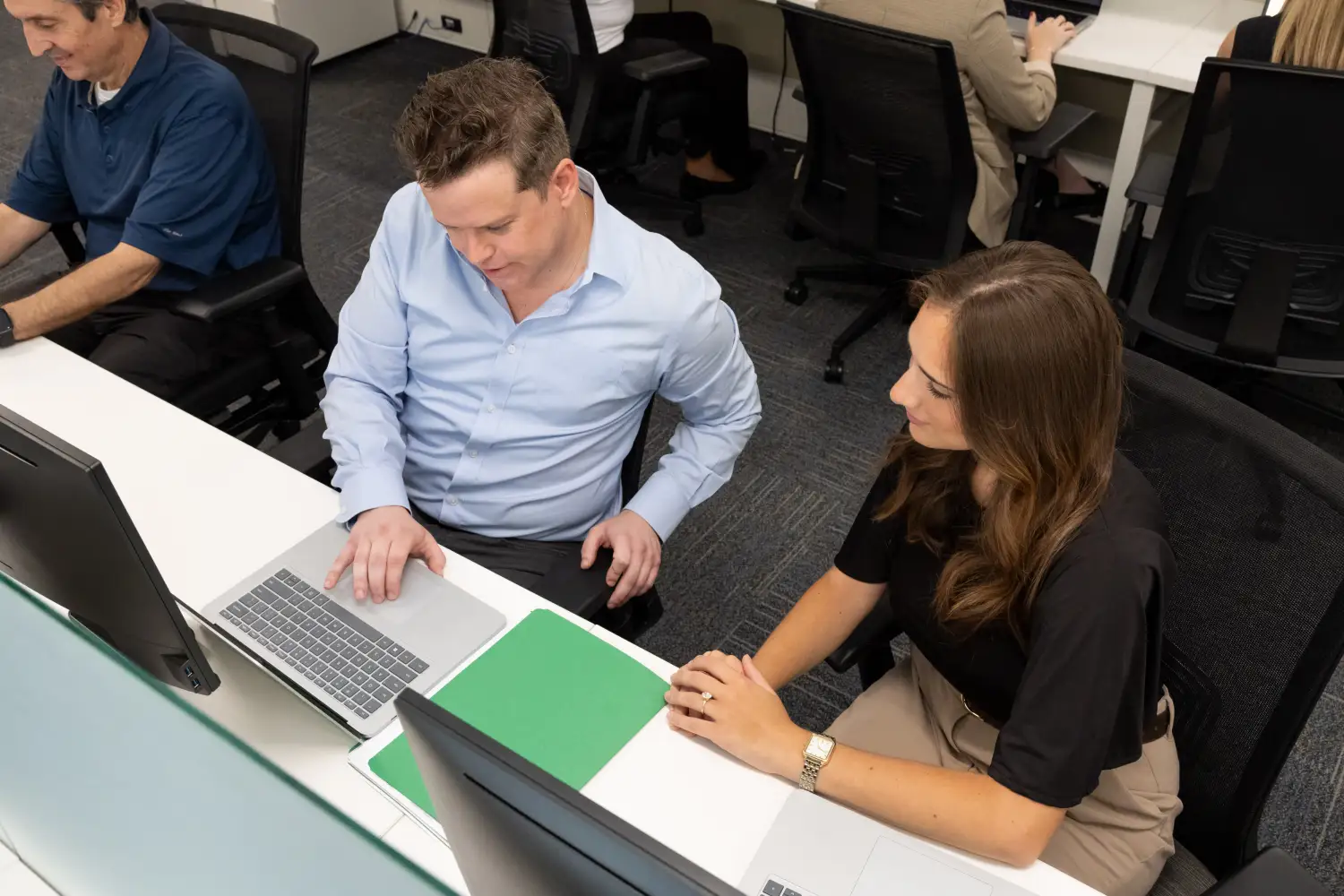 Data analysts using professional services automation with AI to identify customer payment trends and improve DSO