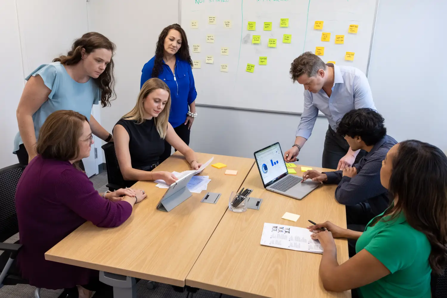 Services professionals using Certinia PS Cloud to analyze real-time data and brainstorm billing automation solutions